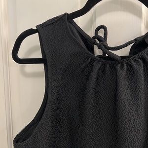 Cute structured black top with tie details in the back